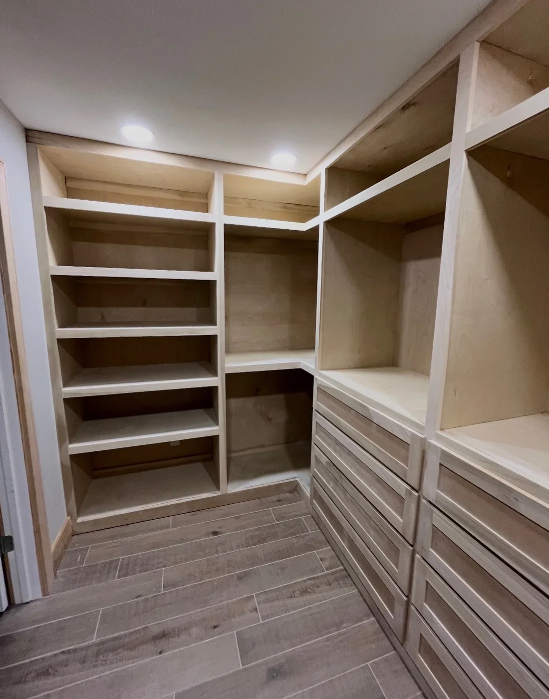 Fitted walk-in closet with open shelves and drawer storage