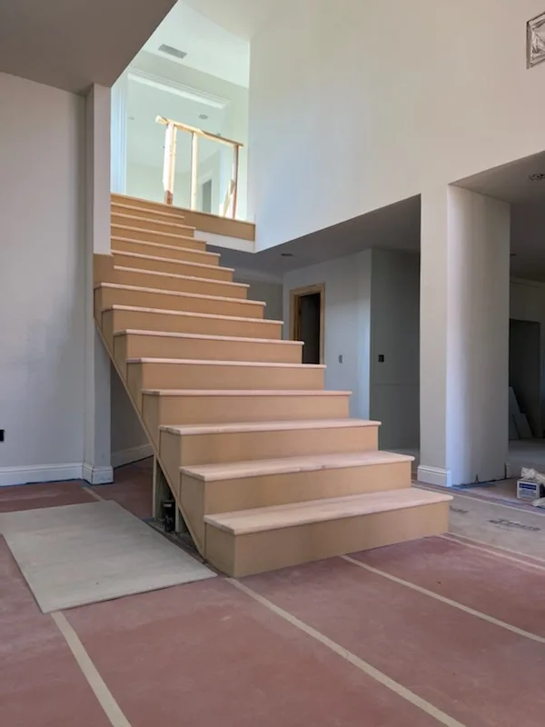 Wood staircase with a matching handrail and newel posts
